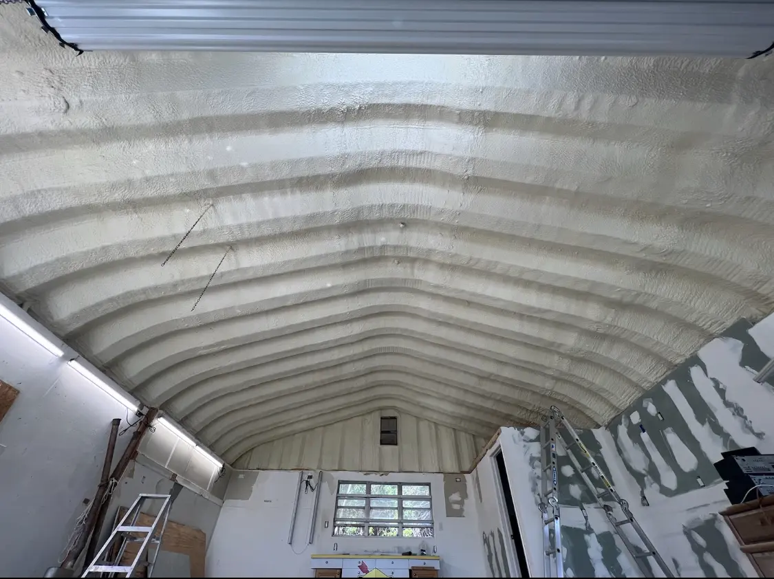 Spray polyurethane foam applied to the underside of a metal roof deck in Adelanto